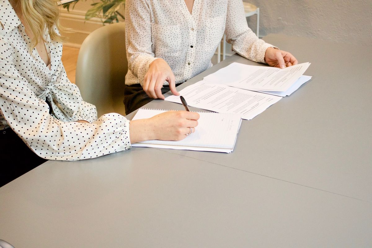 Two women at a table going over tax documents. 