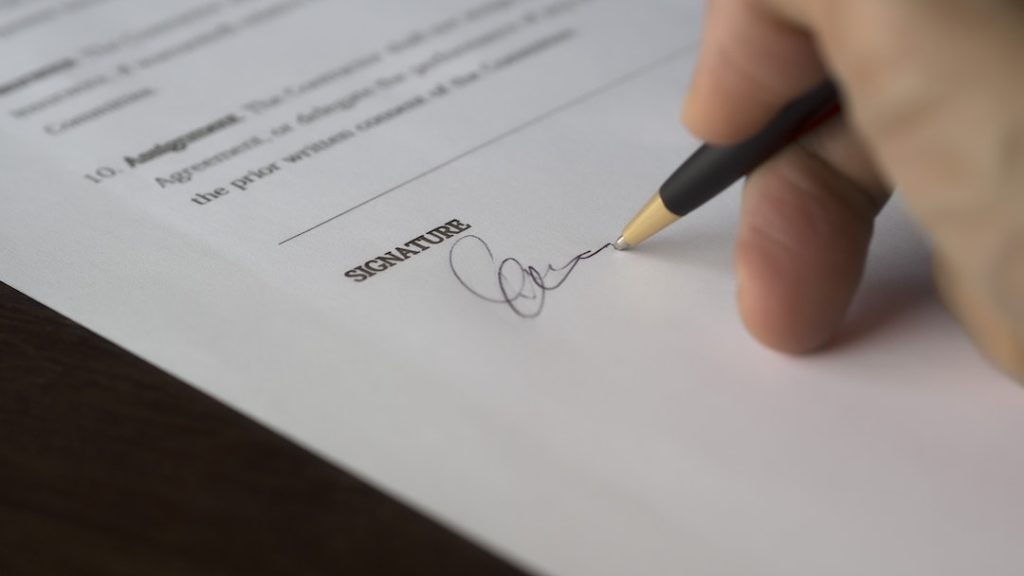  A man signing a document