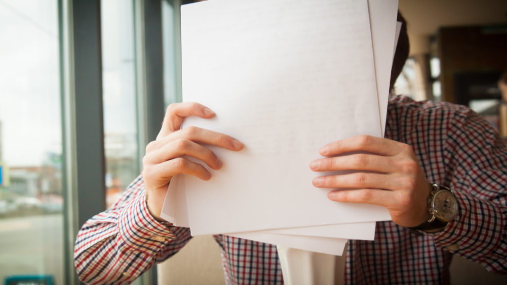 A man gathering the financial documents necessary for revenue reconciliation