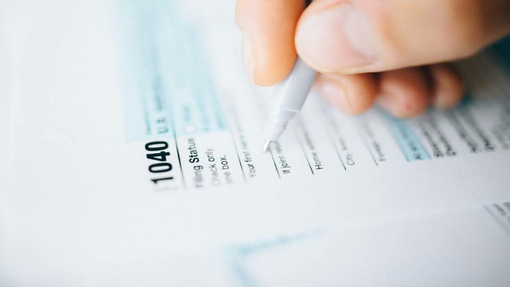 Person filling out tax papers