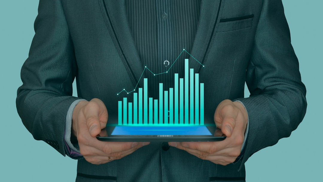 Accountant holding a tablet showing growth on a graph