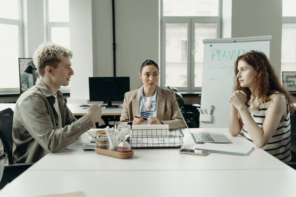 Three people in a planning meeting
