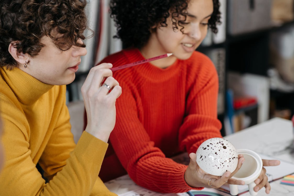  Two people looking at a model at a table