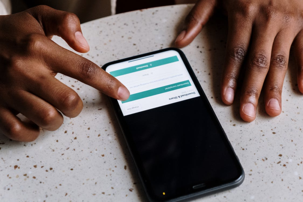 A man downloading a balance sheet template to his smartphone
